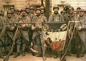 Autochrome of the 114 Infantery regiment in París, on 14 July 1917, with French flag unfurled laying on stacked arms