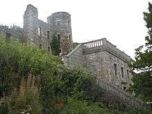 photo of steps leading to terrace with three storey ruins of round tower behind