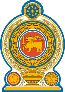 Coat of arms of Sri Lanka, showing a lion holding a sword in its right forepaw surrounded by a ring made from blue lotus petals which is placed on top of a grain vase sprouting rice grains to encircle it. A Dharmacakra is on the top while a sun and moon are at the bottom on each side of the vase.