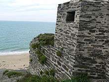 Overgrown concrete structure on beach