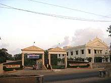 Two gateways next to white building