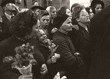 A group of people waiting for a glimpse of homecoming prisoners.