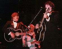 A color photograph of Don and Phil Everly on stage with guitars