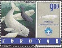 Photo of stamp showing two adults and one juvenile, swimming