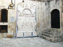 Light gray bas-relief on church wall, with one representative of each side facing each other