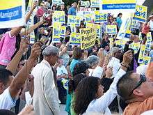 photograph of a throng of people holding signs