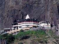 White coloured temple shrine located on the hill top.