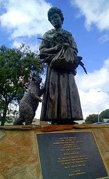 Bronze statue of Colonial American woman with a basket of rosemary and a raccoon