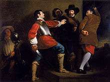 In a stone-walled room, several armed men physically restrain another man, who is drawing his sword.