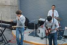 Photograph of a group playing instruments in an amphitheater.