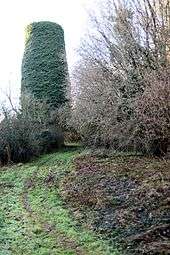 Disused railway line and stone pillar of old viaduct.