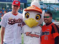 Vinny Eagle poses with US military personnel baseball players.