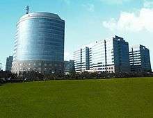 City panorama showing gardens, clean roads and modern office buildings