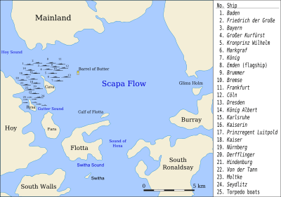 Symbols of ships are arrayed in a portion of water mostly surrounded by land.