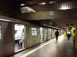 A train with its doors open at the Jamaica Center station