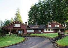 Photograph of the main house in 2011, driveway in the foreground.