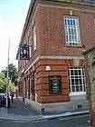 A two-storey brick public house, formerly used as a post office