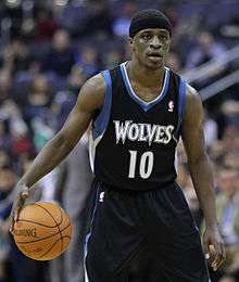 Jonny Flynn, wearing a black headband, dribbling the basketball