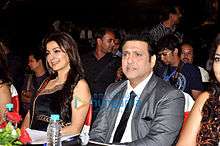 Govinda and Juhi Chawla, seated at a table