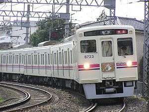 White commuter train on railroad track