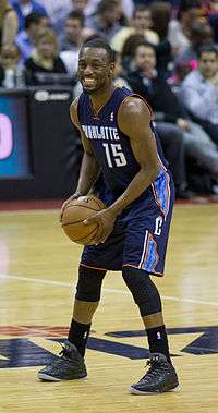 Kemba Walker on the court with a ball in his hands.