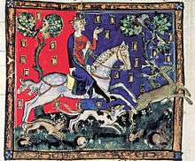 An illuminated picture of King John riding a white horse and accompanied by four hounds. The king is chasing a stag, and several rabbits can be seen at the bottom of the picture.