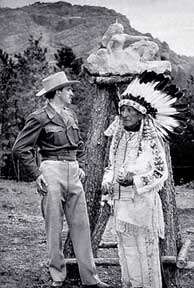 Korczak Ziolkowski and Henry Standing Bear with Thunderhead Mountain, site of Crazy Horse Memorial, in the background and Ziolkowski's monument sculpture model immediately behind them.  The photo was taken before work on Thunderhead Mountain was begun in 1948.