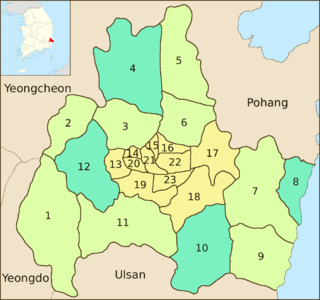 Map of the coastal district previously mentioned. Its center, covering about a sixth of the area, is divided into 11 subdivisions. The surrounding regions are divided into eight subdivisions in a different color. The rest, four subdivisions in a third color, are scattered to the northeast, west, southeast and east respectively.