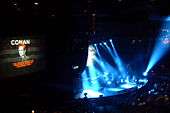 The stage of a concert hall with blue flood lights.