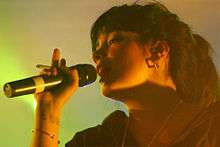 Close-up colour photograph of Lily Allen performing live in 2007.