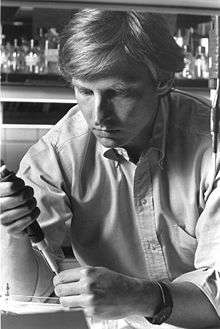 Black and white photograph of a man in a laboratory