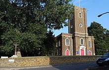 Photograph of the outside of the church showing the entrance and tower viewed from the northwest