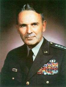 Portrait of middle-age man in military uniforms set against a dark background