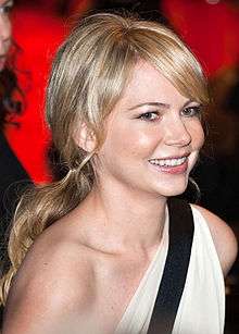 Michelle Williams smiles away from the camera