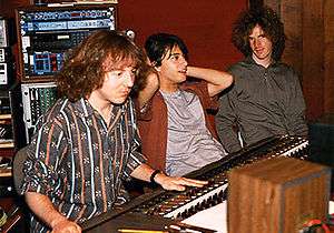 Mitch Easter sitting at a mixing board next to Michael Quercio and Scott Miller