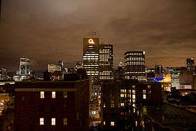 Montreal skyline at night with the Hydro-Québec Building in the center.