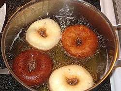 Rings of dough in oil, varying in colour from light to dark