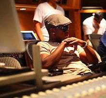 A picture of young African-American man in a recording studio who is looking forward