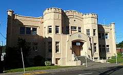 Photograph of a two-story building resembling a castle