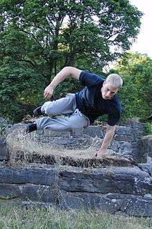 A traceur performing a speed vault