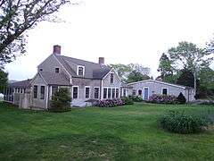 This is a large farmhouse that with a sun room and greenhouse in the back.