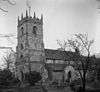 A stone Gothic church with a pinnacled tower