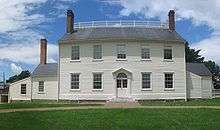 Photograph of a two-story, white clapboard house