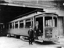 New Orleans Public Service's Prytania streetcar line, 1907. Two uniformed men stand by entrance, presumably the motorman and the conductor. Streetcar is probably at Prytania Station carbarn.