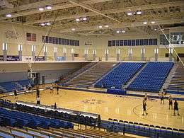 Players warming up as seen from the away bleachers in RIMAC Arena.