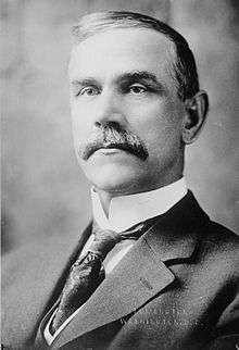 Upper-body portrait of a early-twentieth-century man in a suit.