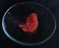 Red powder on a watch glass