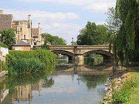 Two arched bridge crossing tree lined river