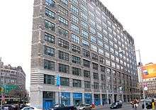 Building facade with interior window treatments reading "The Jackie Robinson Museum"