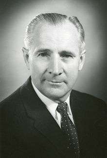 Man in a suit and tie with combed back hair